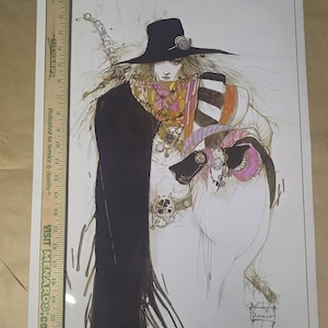 May include: An illustration of a figure in a wide-brimmed hat and long coat, with ornate jewelry and a sword. The artwork features a mix of black, white, and pastel colors, with Japanese text and an artist's signature in the lower right corner.