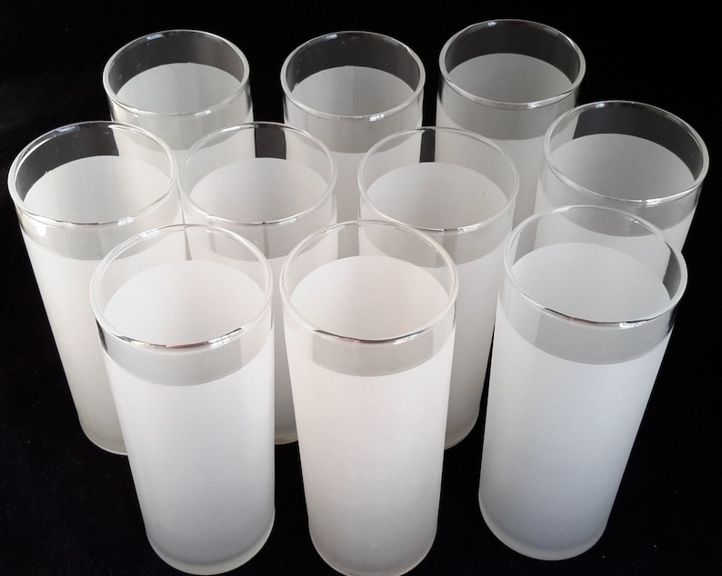 May include: Set of ten frosted glass tumblers. The glasses are clear with a frosted white band around the top.
