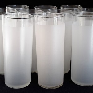 May include: Set of eight frosted glass tumblers. The glasses are clear with a frosted finish and have a cylindrical shape.