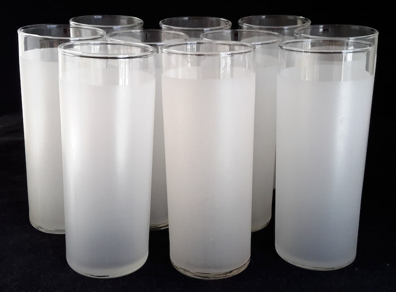 May include: Set of eight frosted glass tumblers. The glasses are clear with a frosted finish and have a cylindrical shape.