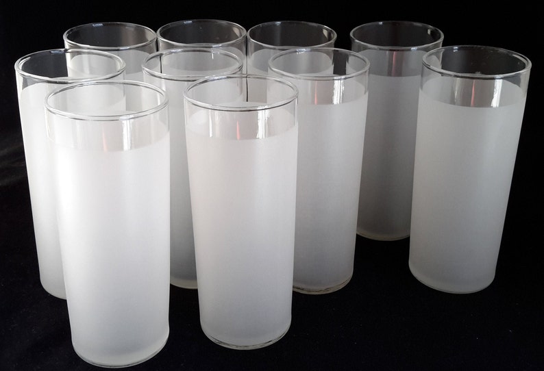 May include: Set of ten frosted glass tumblers. The glasses are clear with a frosted finish and a thin, clear rim.