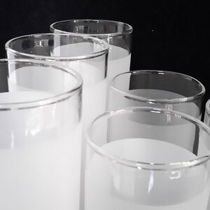 May include: Six frosted glass tumblers with a white frosted finish. The glasses are stacked in a pyramid shape.