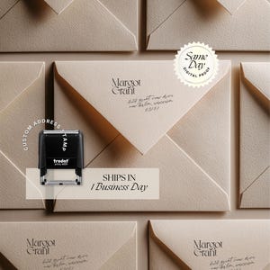 May include: A black Trodat Printy 4929 self-inking custom address stamp positioned over a beige envelope. The envelope features the printed name Margot Grant and the address 424 Grant View Drive, New Berlin, Wisconsin 53151 in a dark serif font.