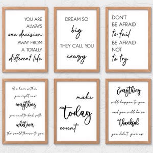 May include: Six framed prints with inspirational quotes in black script on white backgrounds. The frames are a light brown color. The quotes include phrases like "Dream Big" and "Make Today Count."