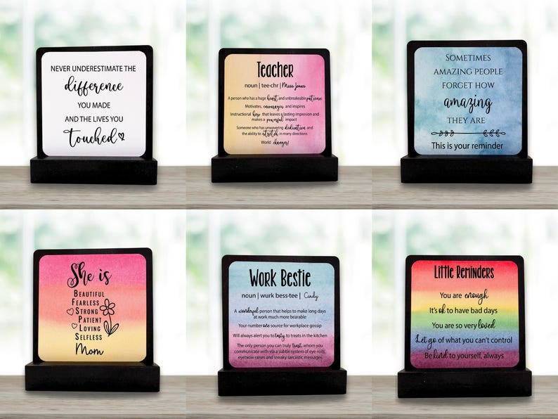 May include: Six decorative wooden plaques with motivational quotes and definitions. Each plaque has a black base and a colourful top with text. The plaques are designed for display on a desk or shelf.