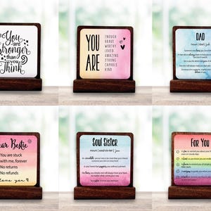 May include: Six wooden desk signs with motivational messages. Each sign has a colourful background and a wooden base. The signs feature phrases such as "You are stronger than you think" and "Soul Sister".