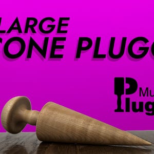 May include: A large wooden cone plug, with a rounded top, lying on a wooden surface. The background is a bright magenta color with the text "LARGE CONE PLUGG" in black. The text "Mugglugg" is also visible in black on the magenta background.