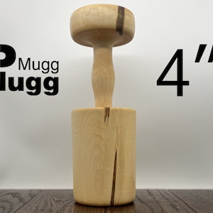 May include: A wooden mallet with a 4 inch diameter head and a handle. The mallet is made of light wood with dark brown streaks.