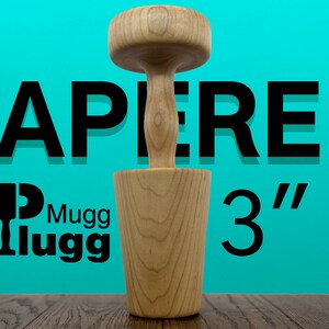May include: A wooden tapered mugg lugg with a 3" diameter. The mugg lugg is made of light brown wood and has a smooth finish.