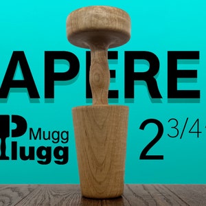 May include: A wooden tapered mallet with a 2 3/4" diameter head. The mallet is made of light brown wood and has a smooth finish. The mallet is sitting on a wooden surface. The text "TAPERED" is visible in the background.