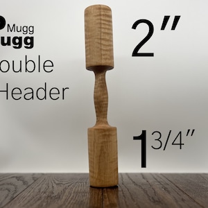 May include: A wooden double-headed mallet with a 2-inch diameter and a 1 3/4-inch length. The mallet is made of light brown wood with a natural grain pattern.
