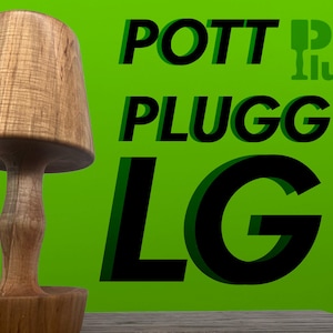 May include: A wooden lamp with a mushroom-shaped shade and a cylindrical base. The lamp is made of light brown wood and sits on a wooden surface. The background is a bright green with the text "POTT PLUGG LG".