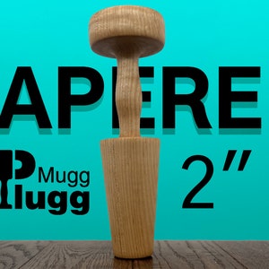 May include: A wooden tapered mug plug, approximately 2 inches tall, with a cylindrical base and a rounded top. The text "TAPERED" and "Mugg Plugg" are visible in the image, set against a teal background.