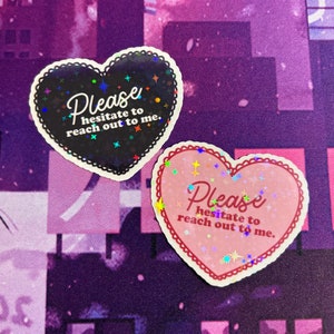 May include: Two heart-shaped stickers with glitter and the text "Please hesitate to reach out to me." The stickers are pink and black.