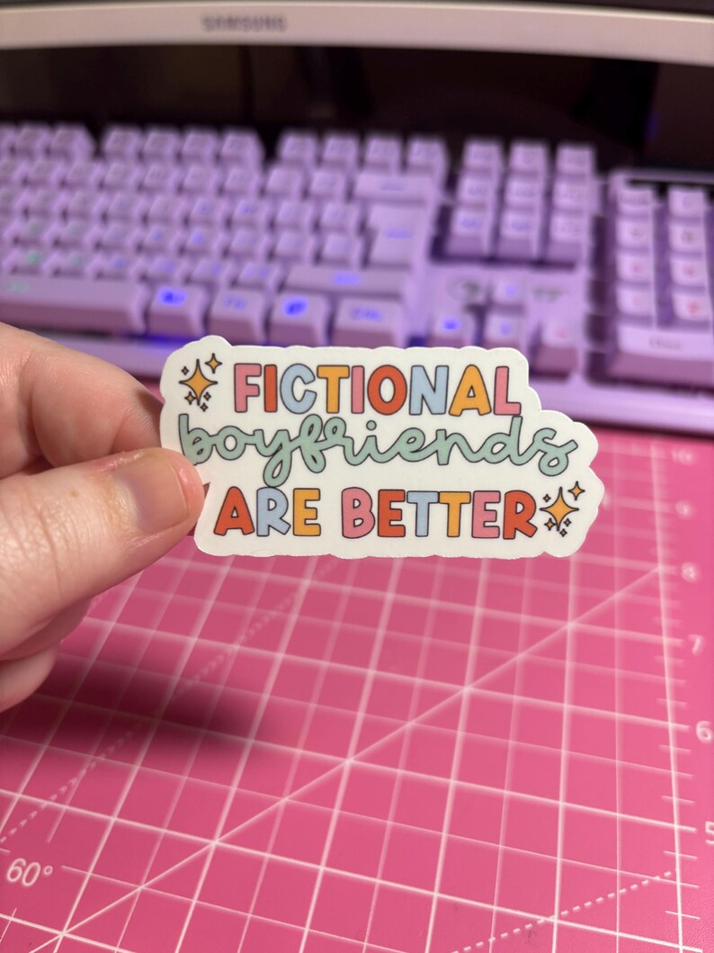 May include: A sticker with the text "Fictional boyfriends are better" in rainbow colors with stars on either side.