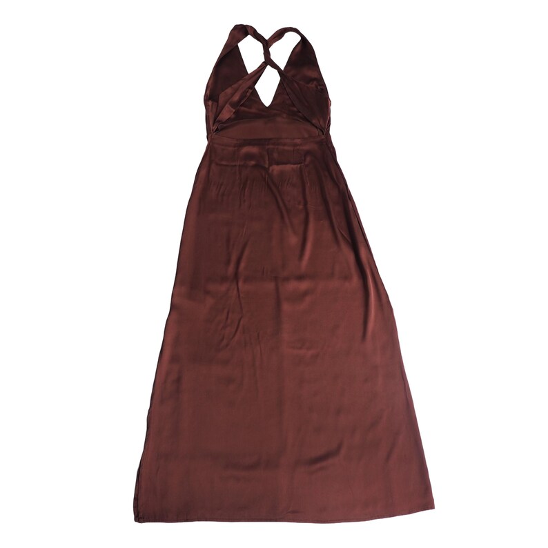 May include: A floor-length, dark brown satin dress featuring a halter neckline with twisted straps that cross at the upper back, leaving the shoulder area exposed. The garment has a smooth, reflective finish and a simple, flowing skirt silhouette.