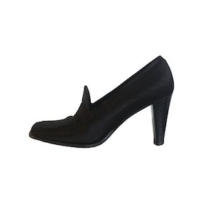 May include: Black satin heeled pumps with a pointed toe and a low vamp.