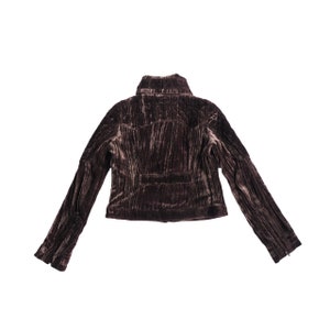 May include: A brown corduroy jacket with a stand-up collar and long sleeves.