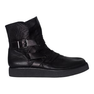 May include: A black ankle boot featuring a smooth leather upper with a slightly wrinkled texture, a rounded toe, and a thick, flat black sole. The boot includes a decorative strap across the side secured with a silver-toned metal buckle.
