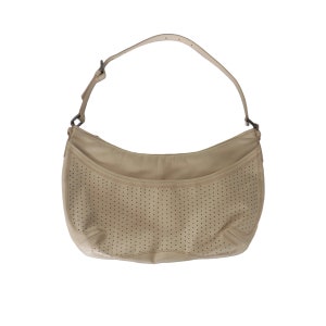 May include: A beige leather handbag with a perforated design. The bag has a single strap and a curved shape.