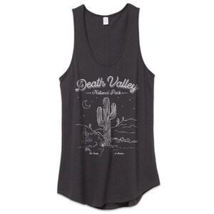 May include: A dark gray tank top with a white graphic of a cactus and the text "Death Valley National Park".