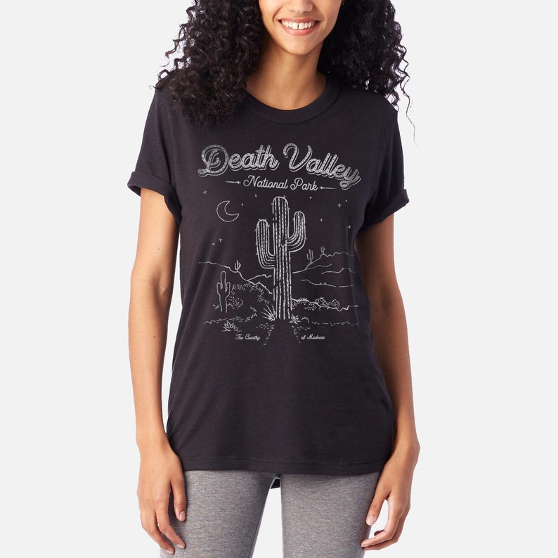 May include: Black t-shirt with a white graphic of a cactus and the text "Death Valley National Park".