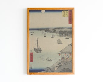 May include: A framed Japanese woodblock print depicting a seascape with boats and a moon in the sky. The print is in shades of blue, gray, and white, with accents of red and black. The text in the image reads "春江暁景" which translates to "Spring River Dawn Scene".