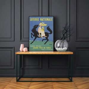Puede incluir: Un cartel vintage que anuncia el "Loterie Nationale" Grand Prix de Par&iacute;s. El cartel presenta un caballo negro con una mujer mont&aacute;ndolo, sosteniendo una bolsa de dinero. El cartel est&aacute; en franc&eacute;s y dice "Tranche Speciale Grand Prix de Paris Tirage le 29 Juin 1957."