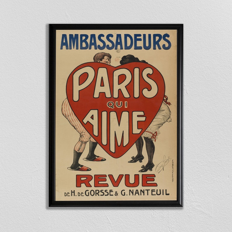 May include: A vintage poster advertising a Parisian revue titled "Paris Qui Aime" with a red heart shape in the centre and two figures in the background. The poster is framed in black and has the text "Ambassadeurs" at the top and "De H. de Gorss&eacute; & G. Nanteuil" at the bottom.