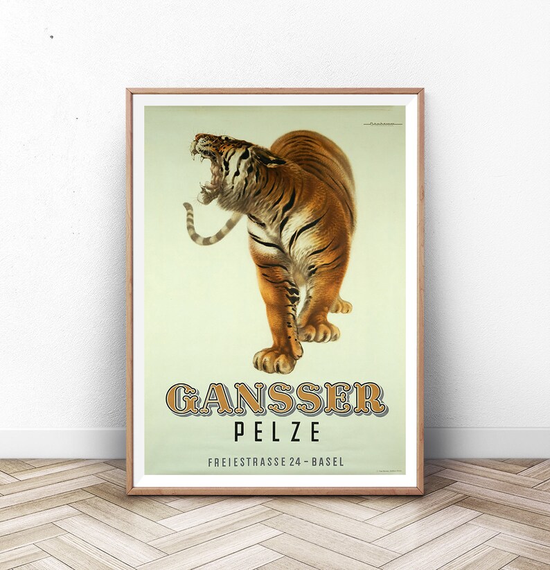 May include: Framed vintage poster featuring a roaring tiger with orange and black stripes. The poster has the text "GANSSER PELZE" in a decorative font, with "FREIESTRASSE 24-BASEL" below. The poster is in a wooden frame.