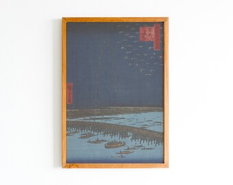 May include: A framed print of a Japanese woodblock print depicting a nighttime scene with a bridge and boats. The print is in shades of blue, black, and red.