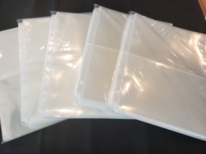 May include: A stack of five clear plastic photo sleeves with a hole punched in the top corner.