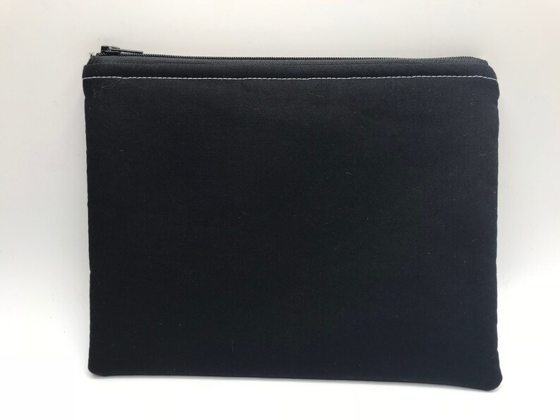 May include: A black zippered pouch with a white zipper and white stitching.