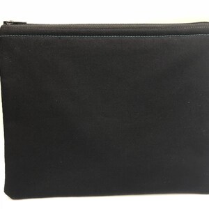 May include: A black zippered pouch with a teal zipper and stitching.