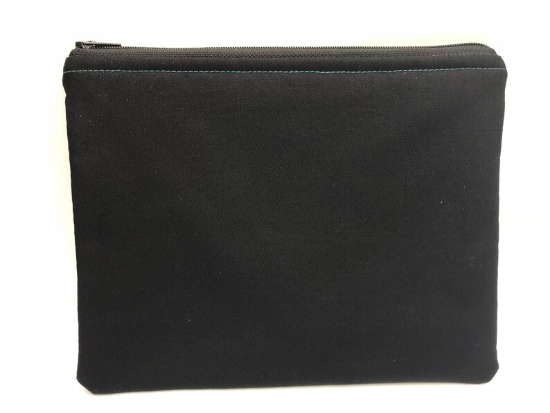 May include: A black zippered pouch with a teal zipper and stitching.