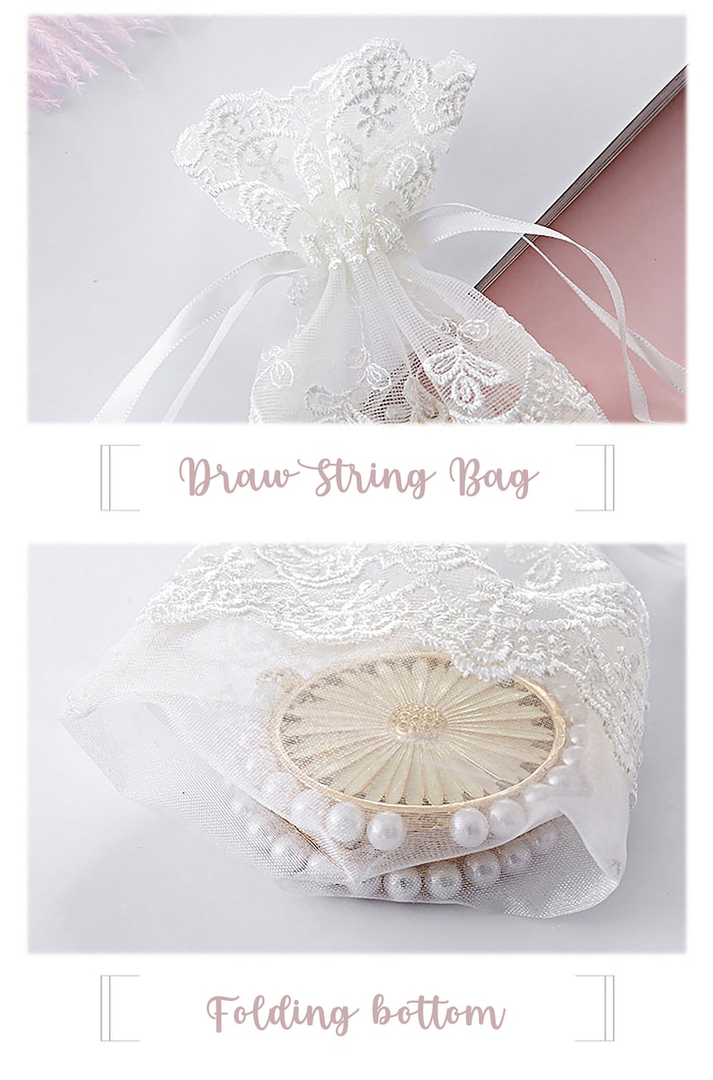 May include: White lace drawstring bag with a white ribbon. The bag is filled with white pearls and a gold-colored decorative item. The bag has a folded bottom.