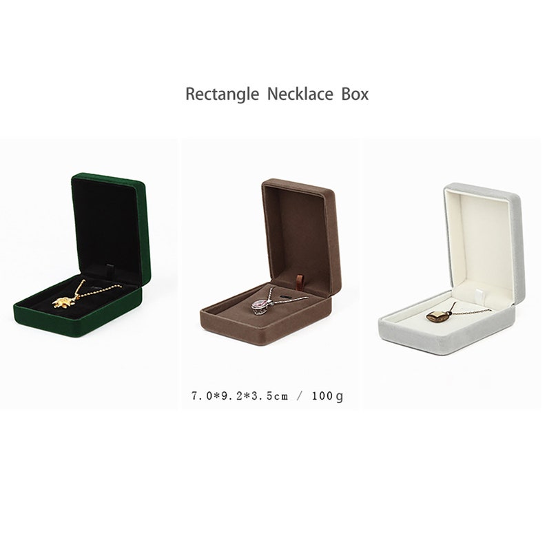 May include: Three velvet jewelry boxes in green, brown, and gray, each with a necklace inside. The boxes are 7 inches by 9 inches by 3.5 inches and weigh 100 grams.