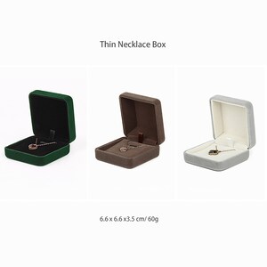 May include: Three velvet jewelry boxes in green, brown, and gray. Each box is open and has a necklace inside. The boxes are 6.6 x 6.6 x 3.5 inches and weigh 60 grams.