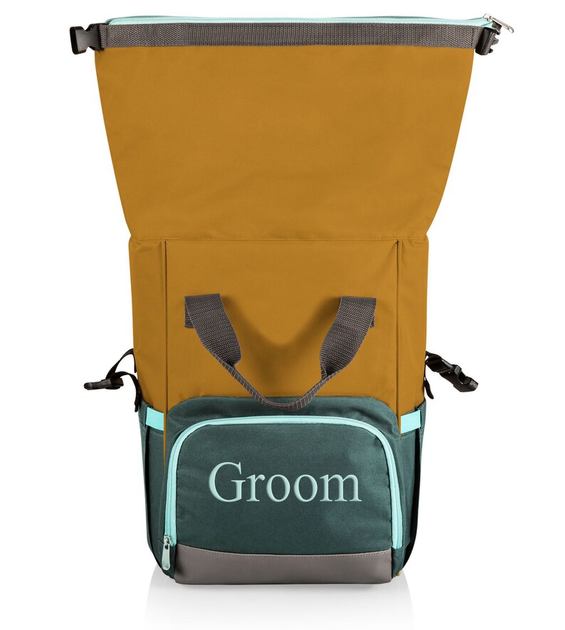 May include: A mustard yellow and teal backpack cooler with the word "Groom" embroidered on the front pocket. The cooler has a grey handle and trim, and a teal zip. It is designed to keep items cold.