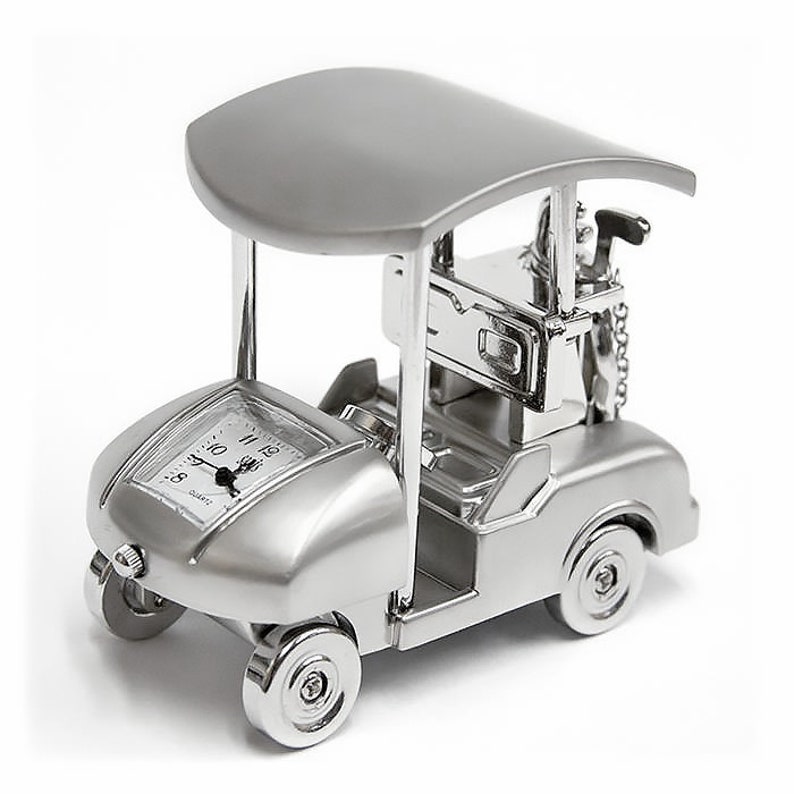 May include: A silver golf cart clock with a black face and white hands. The clock has a black canopy and a silver golf club on the back.