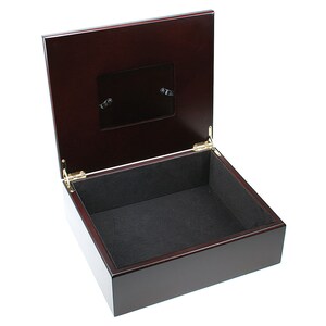 May include: A dark wood box with a hinged lid and a small picture frame on the top. The box is lined with black velvet.