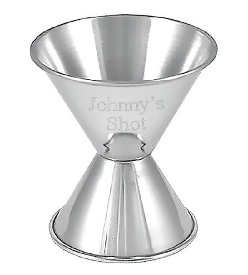 May include: A silver double-ended jigger with the words "Johnny's Shot" engraved on the side.