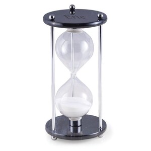 May include: An hourglass with a black base and top, connected by silver metal rods. The clear glass bulbs contain white sand. The top of the hourglass has the name "Eric" engraved on it.