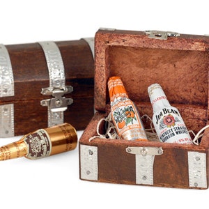 May include: Two miniature chocolate liquor bottles, one Jim Beam and one orange flavored vodka, inside a small wooden treasure chest with silver accents.