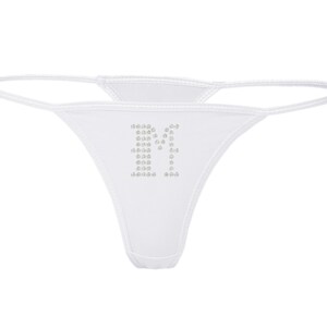 May include: White thong underwear with the letter "F" spelled out in small, silver rhinestones. The thong features a minimalist design with thin straps and a low-rise cut, perfect for everyday wear.