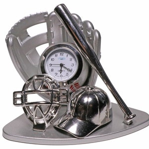 May include: Silver baseball themed desk clock with a baseball glove, bat, cap, and a home plate. The clock face is white with black hands and black numbers.