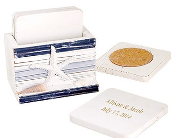 May include: Set of six white coasters with a blue and gray striped design, featuring a starfish and seashells. The coasters come in a holder with the same design. One coaster has a cork backing and another has the text "Allison & Jacob July 17, 2014".
