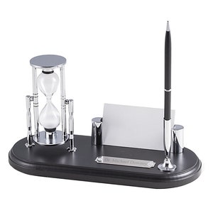 May include: A black desk organizer with a silver hourglass, pen holder, and business card holder. The organizer has a silver nameplate that reads "Dr. Michael Downey".