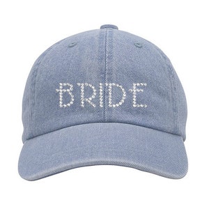 May include: A light blue denim baseball cap with the word "BRIDE" spelled out in rhinestones.