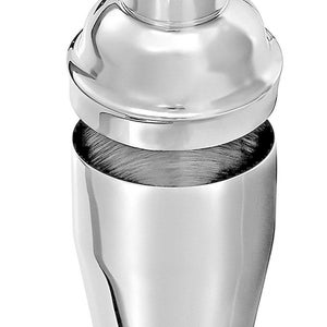 May include: A silver cocktail shaker with a lid and a strainer. The shaker has a smooth, polished finish.